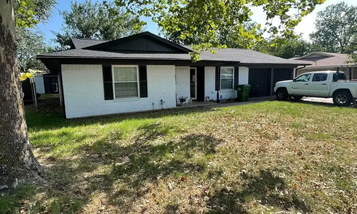 Professional roofing crew working on a residential roof in Prairie Village